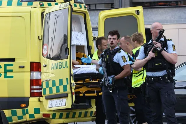 An ambulance and armed police outside the Field's shopping center, in Orestad, Copenhagen, Denmark, Sunday, July 3, 2022, after reports of shots fired. Danish police say several people have been shot at a Copenhagen shopping mall. Copenhagen police said that one person has been arrested in connection with the shooting at the Field’s shopping mall on Sunday. Police tweeted that “several people have been hit” but gave no other details. (Photo by Olafur Steinar Gestsson/Ritzau Scanpix via AP Photo)