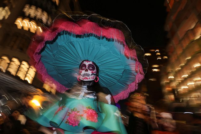 A woman in costume poses for a photo during the annual NYC Halloween Parade in Manhattan in New York City on October 31, 2024. (Photo by Kent J. Edwards/Reuters)