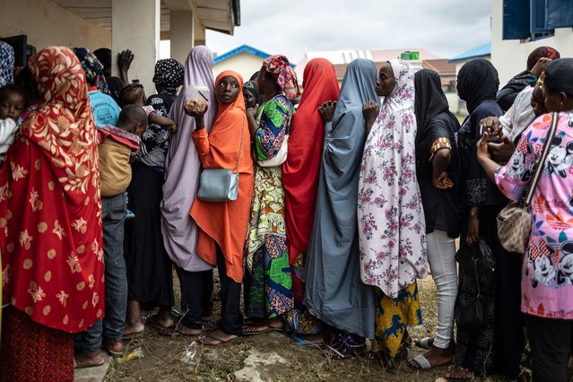 Internally displaced persons from the flood queue at St. Luke school used as a shelter in Lokoja on October 22, 2024. Human-caused climate change worsened floods that have killed hundreds of people and displaced millions in Cameroon, Chad, Niger, Nigeria and Sudan this year, according to a study published on October 23, 2024. (Photo by Olympia de Maismont/AFP Photo)