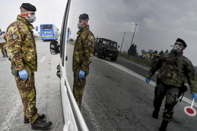 Italian Army soldiers check transit to and from the cordoned areas near Turano Lodigiano, Northern Italy, Tuesday, February 25, 2020. Civil protection officials on Tuesday reported a large jump of cases in Italy, from 222 to 283. Seven people have died, all of them elderly people suffering other pathologies. (Photo by Claudio Furlan/Lapresse via AP Photo)