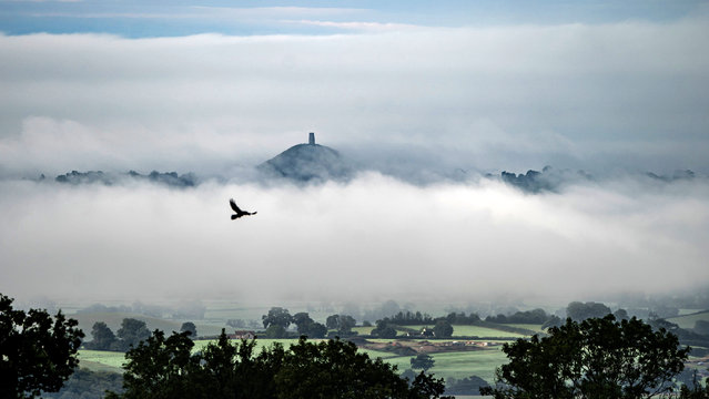 After heavy rain over the Somerset Levels clouds and mist form below St Michael's Tower, atop Glastonbury Tor, as it pokes above the morning mist on Saturday, September 7, 2024. (Photo by Ben Birchall/PA Wire)