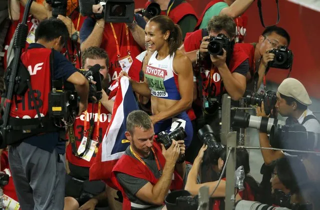 Jessica Ennis-Hill is surrounded by photographers as she celebrates winning the women's heptathlon during the 15th IAAF World Championships at the National Stadium in Beijing, China August 23, 2015. (Photo by Fabrizio Bensch/Reuters)