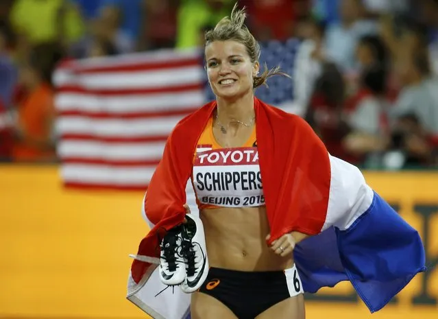 Second placed Dafne Schippers of Netherlands celebrates with a national flag after competing in the women's 100 metres final during the 15th IAAF World Championships at the National Stadium in Beijing, China, August 24, 2015. (Photo by Damir Sagolj/Reuters)