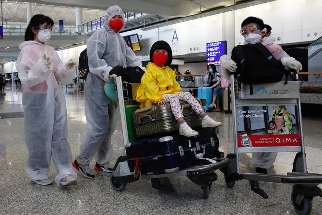 Passengers wear protective suits, amid the outbreak of coronavirus, at Hong Kong International Airport, Hong Kong, China on March 17, 2020. (Photo by Tyrone Siu/Reuters)