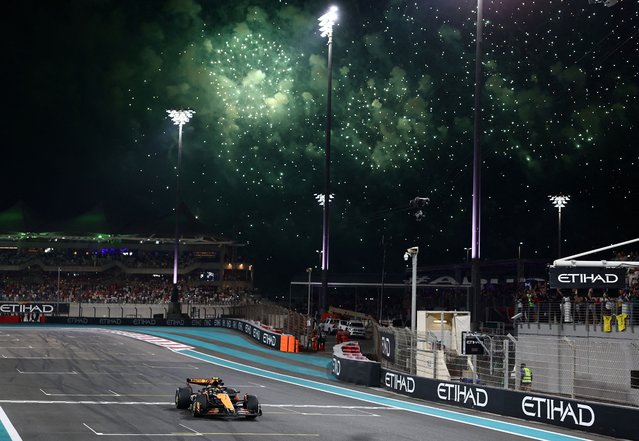 McLaren's British driver Lando Norris crosses the finish line to win the Abu Dhabi Formula One Grand Prix at the Yas Marina Circuit in Abu Dhabi on December 8, 2024. (Photo by Jakub Porzycki/Reuters)