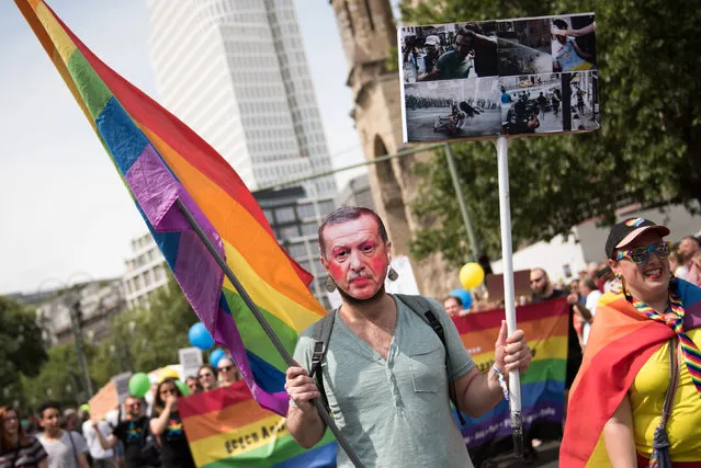A man wearing a mask with a picture of Turkish President Tayyip Erdogan participates in the annual Gay Pride parade, also called Christopher Street Day parade (CSD), in Berlin, Germany July 23, 2016. (Photo by Stefanie Loos/Reuters)