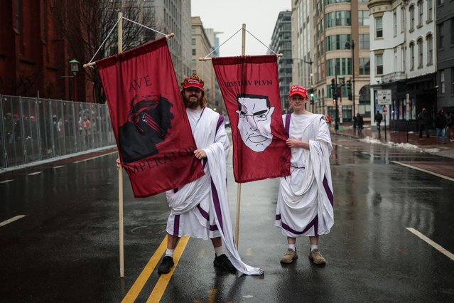 Logan Howard (L), a 27-year-old from Tennessee, and Jacob Schnabel, a 22-year-old from Wisconsin, pose for a picture outside Capital One Arena, ahead of a rally for U.S. President-elect Donald Trump the day before he is scheduled to be inaugurated for a second term, in Washington, U.S., January 19, 2025. “This is a culmination of a democracy, you know, centuries in the making, one that inspired so much”, said Howard. “And so to be able to witness it once, I think, is something that one should do, like a pilgrimage”. (Photo by Marko Djurica/Reuters)