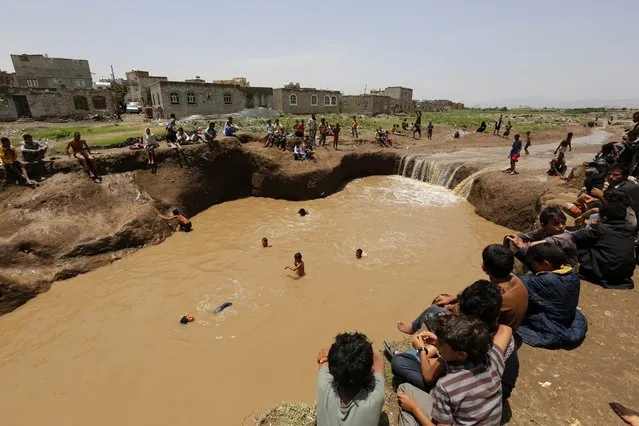 A general view shows Yemenis swimming in floodwaters following a heavy rain in Sana'a, Yemen, 04 August 2016. Heavy torrential rains triggered flash floods in the capital Sana’a and several parts of Yemen. (Photo by Yahya Arhab/EPA)