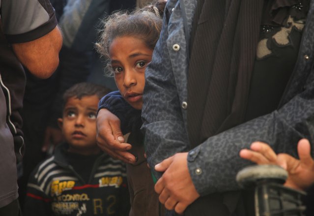 A Palestinian looks on as she stands along with people gathered to receive aid boxes provided by UNRWA, following a ceasefire between Israel and Hamas, in Khan Younis in the southern Gaza Strip, on January 21, 2025. (Photo by Hatem Khaled/Reuters)