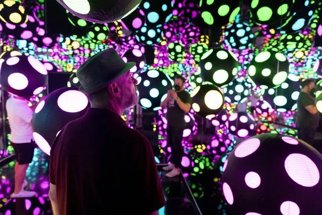 Visitors enter an “Infinity Mirror Room” entitled “My Heart is Dancing Into the Universe”, which is part of the exhibit 'One with Eternity' featuring the work of artist Yayoi Kusama, at the Hirshhorn Museum in Washington, DC, USA, 24 August 2022. The Hirshhorn Museum is a popular tourist site in the US capital. (Photo by Michael Reynolds/EPA/EFE)