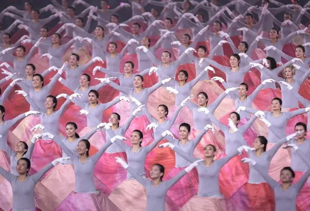 Female dancers perform a coordinated routine during the 51st National Day parade at the National Stadium in Singapore, 09 August 2016. The National Day of Singapore is celebrated every year on 09 August in commemoration of its separation from the Federation of Malaysia in 1965. (Photo by Wallace Woon/EPA)