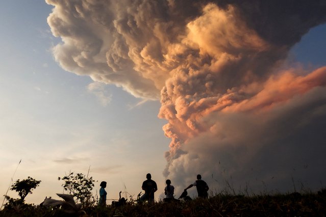 Residents watch the eruption of Mount Lewotobi Laki Laki from Lewolaga village in East Flores, East Nusa Tenggara, Indonesia on November 9, 2024. (Photo by Arnold Welianto/AFP Photo)