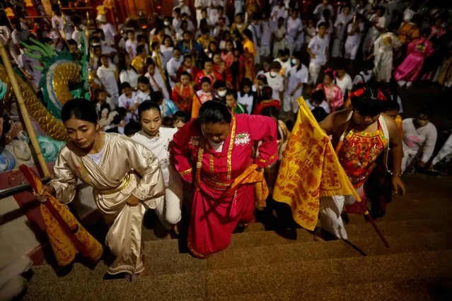 People attend a ceremony at a shrine, during the annual vegetarian festival, observed by Taoist devotees from the Thai-Chinese community, in the ninth lunar month of the Chinese calendar, in Phuket, Thailand on September 28, 2022. (Photo by Jorge Silva/Reuters)