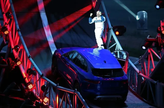 Driver Terry Grant stands on a Jaguar F-PACE after he drove round a giant loop the loop track on September 14, 2015 in Frankfurt, Germany. (Photo by Peter Macdiarmid/Getty Images for Jaguar)