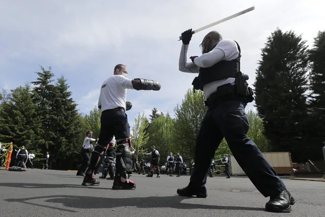 In this June 4, 2020, photo, law enforcement officers at the Washington state Criminal Justice Training Commission training facility in Burien, Wash., take part in a class on the use of batons as part of the more than 700 hours of training police and other officers are required to to through in the state of Washington. Police training has been under scrutiny again since the death of George Floyd, a black man who died after being restrained by Minneapolis police officers. (Photo by Ted S. Warren/AP Photo)