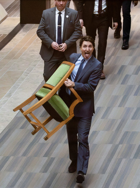 Canada's Prime Minister Justin Trudeau carries his chair from the House of Commons on Parliament Hill in Ottawa, Ontario, Canada, on March 10, 2025. (Photo by Carlos Osorio/Reuters)