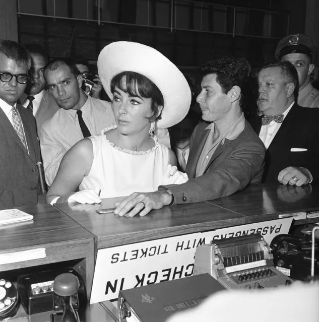 Elizabeth Taylor, left, and Eddie Fisher are shown leaving from Idlewild Airport via an American Airlines Jet for Los Angeles, July 18, 1961, New York. (Photo by AP Photo/Modugno)