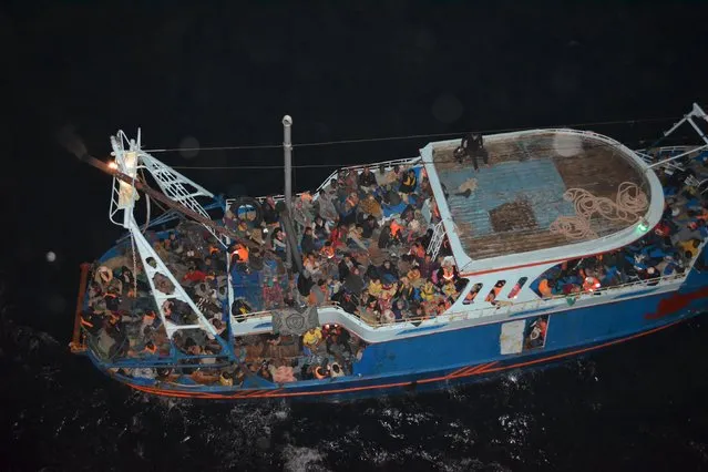 A fishing boat carrying migrants in the Mediterranean is seen from the commercial ship CS Caprice in this handout photograph taken October 22, 2014 and provided to Reuters, September 14, 2015. (Photo by Campbell Shipping/Reuters)