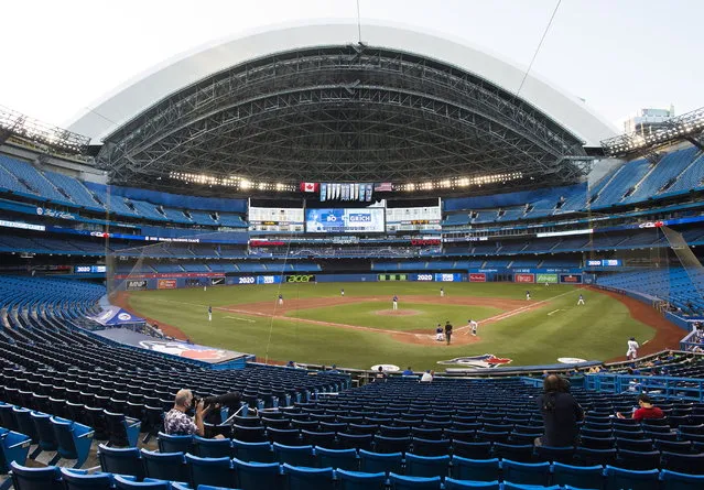 Photographers cover the game in an empty stadium during fourth-inning intrasquad baseball game action in Toronto, Friday, July 17, 2020. (Photo by Nathan Denette/The Canadian Press via AP Photo)