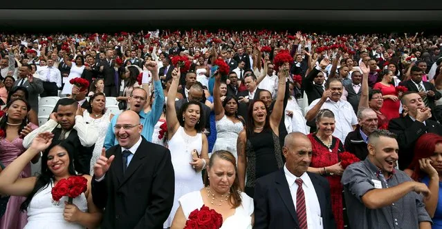 Couples attend a mass wedding ceremony at Arena Corinthians soccer stadium in Sao Paulo, Brazil, September 26, 2015. (Photo by Paulo Whitaker/Reuters)