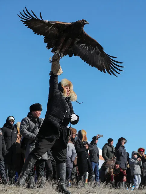 A hunter releases his tamed golden eagle during a traditional competition in the Almaty region, Kazakhstan on November 27, 2022. (Photo by Pavel Mikheyev/Reuters)