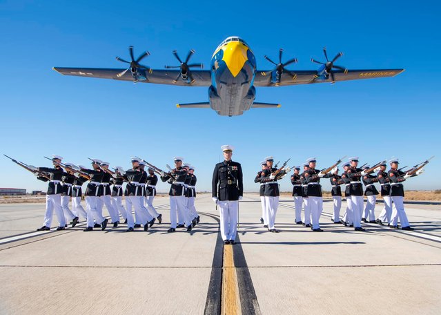Image taken from Facebook of United States Marines with the Silent Drill Platoon executing the “bursting bomb” sequence during the Blue Angels' “Fat Albert” C-130J Super Hercules flyover at Marine Corps Air Station Yuma, Ariz. on February 25, 2025. (Photo by Facebook.com)