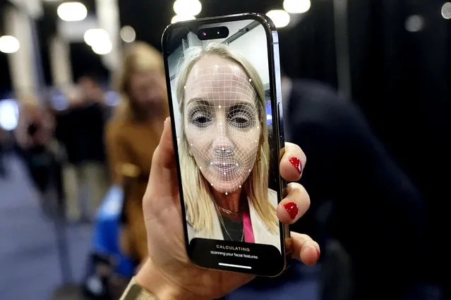 A booth worker demonstrates L'Oreal's smart brow applicator that uses augmented reality to help print eyebrows on the face during CES Unveiled, before the CES tech show, Tuesday, January 3, 2023, in Las Vegas. (Photo by Rick Bowmer/AP Photo)
