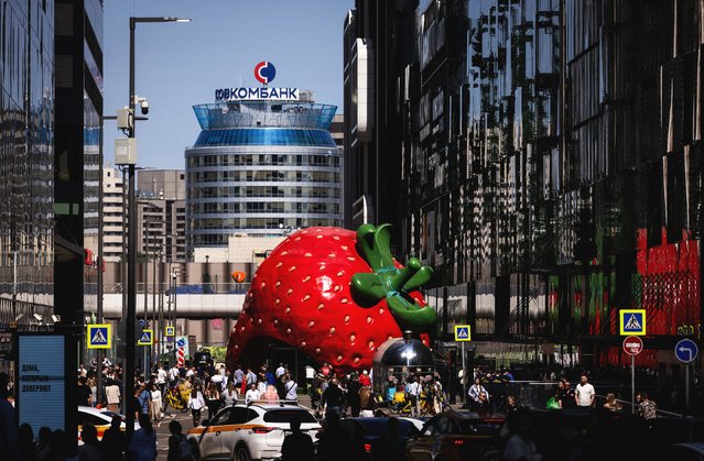 A pavilion in the form of a giant strawberry is seen next to the office of Sovkombank at Moscow International Business Center, also known as Moscow-City, in Moscow, on June 2, 2025. (Photo by Maxim Shemetov/Reuters)