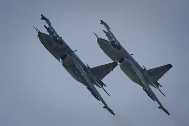 This photo taken on September 24, 2016 shows Sukhoi SU-25 aircraft performing during the first Wonsan Friendship Air Festival in Wonsan. Just weeks after carrying out its fifth nuclear test, North Korea put on an unprecedented civilian and military air force display Saturday at the country's first ever public aviation show. (Photo by Ed Jones/AFP Photo)
