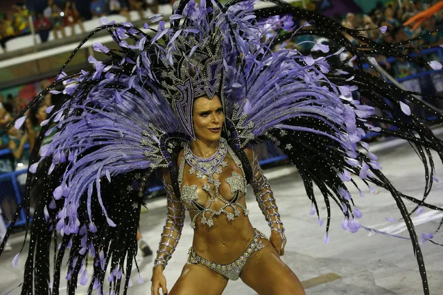 A performer from the Salgueiro samba school parades during Carnival celebrations at the Sambadrome in Rio de Janeiro, Brazil, early Tuesday, February 13, 2018. (Photo by Silvia Izquierdo/AP Photo)
