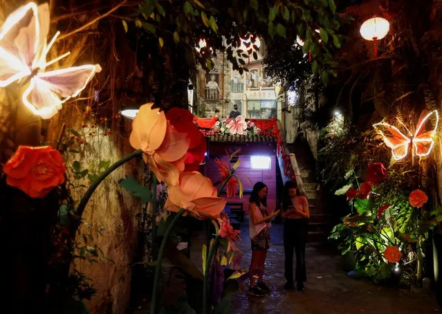 People are seen with Chinese Lunar New Year installation titled “Poetic Spring Garden”, an installation by Kwai Chai Hong at Chinatown, Kuala Lumpur, Malaysia on January 16, 2023. (Photo by Hasnoor Hussain/Reuters)