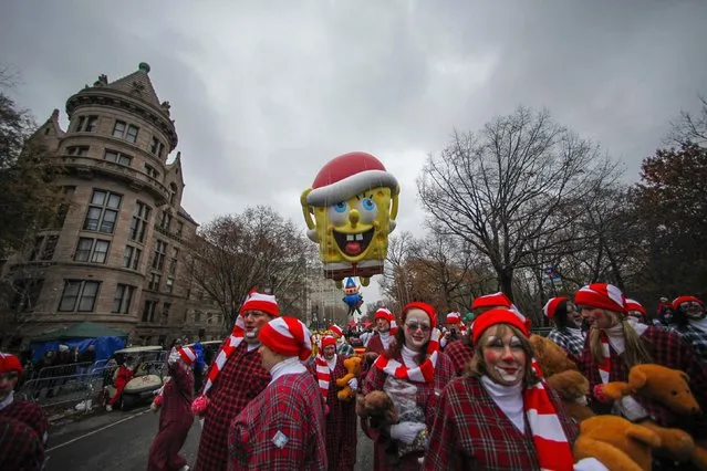 A SpongeBob Squarepants balloon floats down Central Park West during the 88th Macy's Thanksgiving Day Parade in New York November 27, 2014. (Photo by Eduardo Munoz/Reuters)