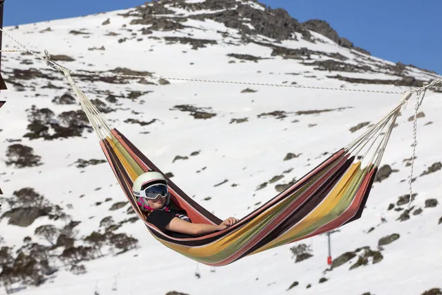 A young girl sits in a hammock enjoying blue skies and spring sunshine on the ski fields on September 14, 2020 in Charlotte Pass, Australia. Visitors to the Charlotte Pass ski resort have been enjoying spring snow conditions, with the ski season expected to continue until 4 October 2020. Charlotte Pass has an elevation of 1837 metres and has escaped some of the higher temperatures in lower resorts which has the snow melting earlier than others. (Photo by Bill Blair#JM/Getty Images)