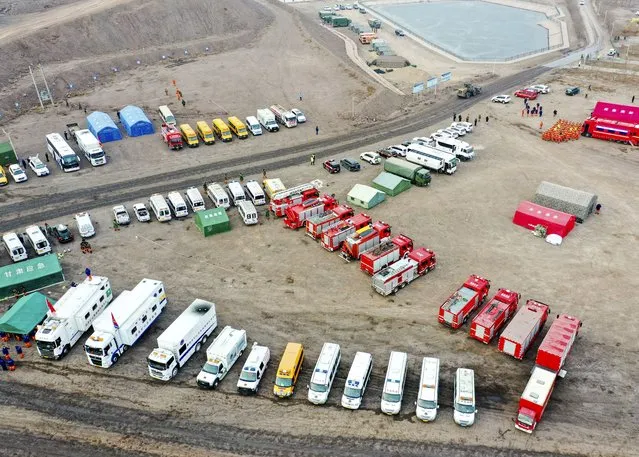In this aerial photo released by China's Xinhua News Agency, rescue vehicles are parked near the site of a collapsed open pit coal mine in Alxa League in northern China's Inner Mongolia Autonomous Region, Thursday, February 23, 2023. An open pit mine collapsed in China's northern Inner Mongolia region on Wednesday, killing multiple people and leaving dozens more missing, state media reported. (Photo by Lian Zhen/Xinhua via AP Photo)
