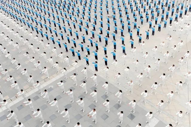 People practice Taichi at a square in Qinyang, Henan province, China, October 18, 2015. (Photo by Reuters/China Daily)