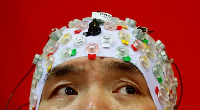 Hong Gi Kim of South Korea competes during the Brain-Computer Interface Race (BCI) at the Cybathlon Championships in Kloten, Switzerland October 8, 2016. On Saturday, the Swiss Federal Institute of Technology ETH Zurich organised the world’s first Cybathlon Championship for Athletes with Disabilities, which sees participants compete against each other using the latest assistive technologies. Seventy-two teams from 25 countries participated in the sold-out event, which was held at the SWISS Arena in Kloten, canton Zurich. Unlike the Paralympics, which focus on athletic performance, the Cybathlon events were designed to identify and showcase the best assistive technologies – such as arm and leg prostheses, robotic exoskeletons, powered wheelchairs, and even brain-machine interfaces – in terms of their ability to help users navigate the tasks and challenges of daily life. (Photo by Arnd Wiegmann/Reuters)