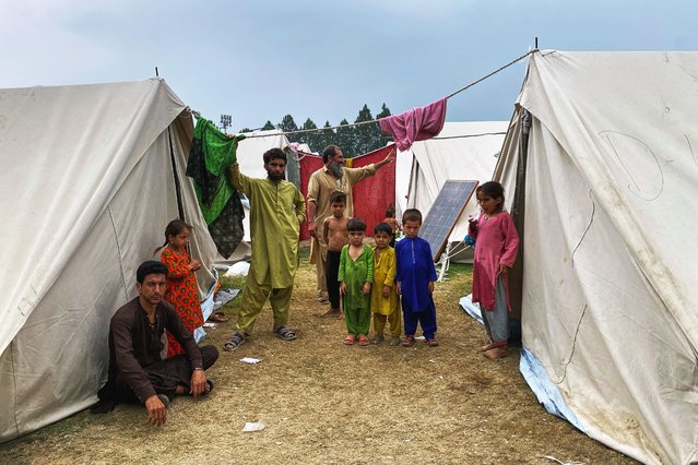 Internally displaced people, who fled their homes after security forces launched a targeted operation against militants, stand at a camp set up in a sports complex at Khar, in the Bajaur district of Khyber Pakhtunkhwa province bordering Afghanistan, Thursday, August 14, 2025. (Photo by Qyass Khan/AP Photo)