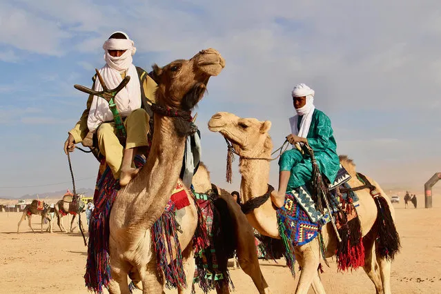 In this photo taken Sunday February 18, 2018, Tuareg men ride on camels during a festival in Iferouane, Niger. (Photo by Ludivine Laniepce/AP Photo)