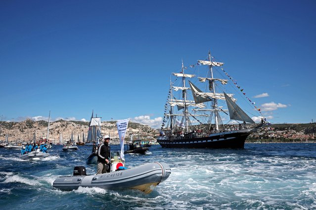 People on boats accompany the Belem, a three-masted sailing ship, as it arrives into the Old Port in Marseille, France on May 8, 2024, carrying the Olympic flame, for the Paris Olympics 2024. (Photo by Benoit Tessier/Reuters)