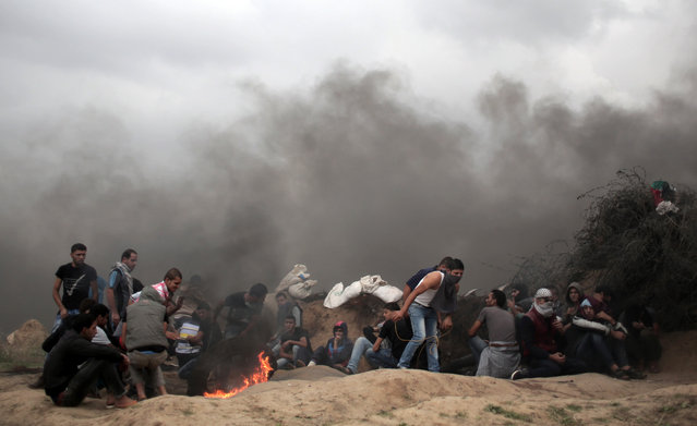 Palestinian protesters clash with Israeli soldiers on the Israeli border with Gaza in Bureij, in the Gaza Strip, Friday, November 6, 2015. (Photo by Khalil Hamra/AP Photo)