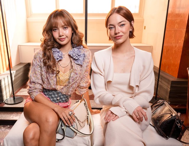 American actress Emma Stone (right) and Thai rapper Lisa at the Louis Vuitton fashion show as part of Spring/Summer 2026 Paris Fashion Week held at The Louvre on September 30, 2025 in Paris, France. (Photo by Swan Gallet/WWD via Getty Images)