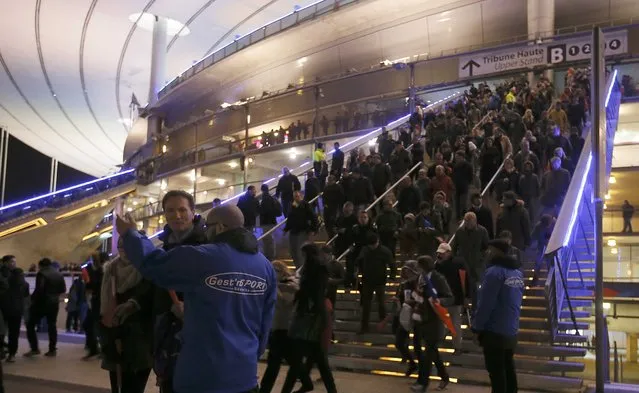 Crowds leave the Stade de France where explosions were reported to have detonated outside the stadium during the France vs German friendly match near Paris, November 13, 2015. (Photo by Gonazlo Fuentes/Reuters)