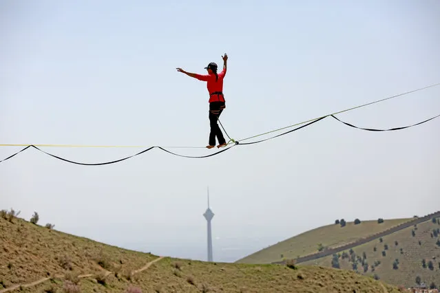 31 year-old female extreme sport athlete Farzaneh Shahsavand finding balance while slack-lining training in a mountain range near Tehran, Iran on April 09, 2023. (Photo by Fatemeh Bahrami/Anadolu Agency via Getty Images)