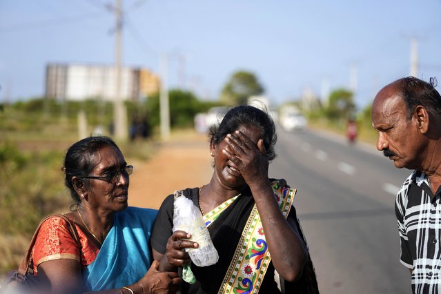 Senthilvel Sothiladchumi, an ethnic Sri Lankan Tamil, center, whose son went missing during the Sri Lankan civil war, cries as she leaves the site of a mass grave where authorities exhibited unearthed belongings in an effort to secure the identities of the victims, in Chemmani, Sri Lanka, August 5, 2025. (Photo by Eranga Jayawardena/AP Photo)