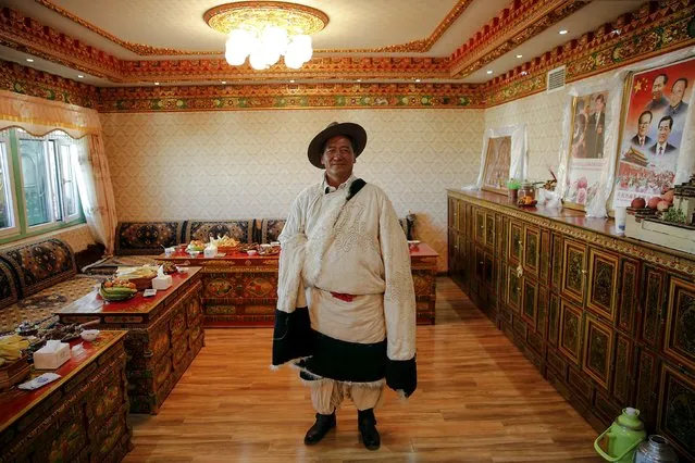 A Tibetan herdsman Lob Sang poses in his home decorated with pictures of Chinese leaders after being visited by foreign reporters on a government organised tour in Damxung county of the Tibet Autonomous Region, China November 18, 2015. (Photo by Damir Sagolj/Reuters)