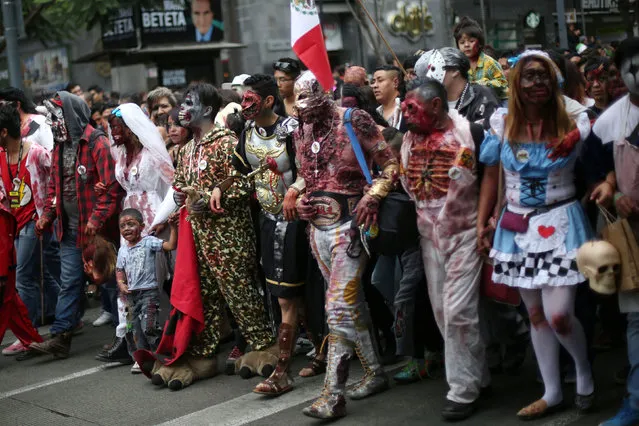 People dressed as zombies participate in a Zombie Walk procession in Mexico City, Mexico, October 22, 2016. (Photo by Edgard Garrido/Reuters)