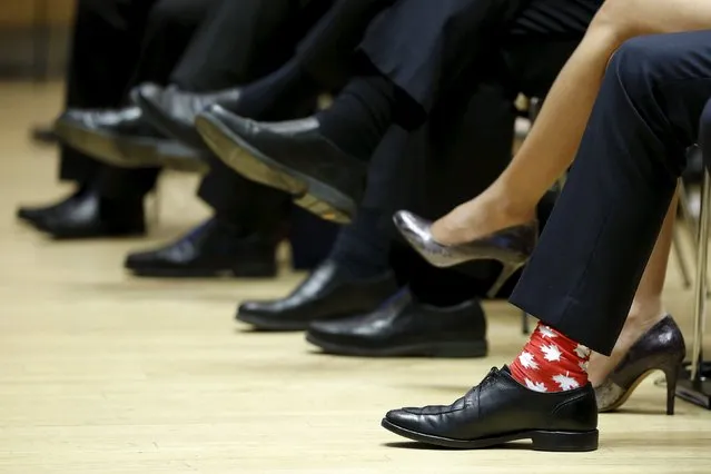 Canada's Prime Minister Justin Trudeau (R) wears maple leaf-themed socks during the First Ministers' meeting in Ottawa, Canada November 23, 2015. (Photo by Chris Wattie/Reuters)