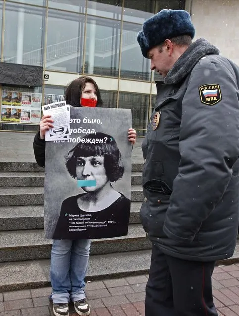 A gay rights activist holds a board displaying 19th century Russian poet Marina Tsvetaeva during an unsanctioned protest rally to defend the rights of Russian gays and lesbians in St. Petersburg, in this April 7, 2012 file photo. Along with a planned new law banning the spread of gay “propaganda” among minors, President Vladimir Putin has also overseen a religious revival that aims to give the Orthodox Church, whose leader has suggested that homosexuality is one of the main threats to Russia, a more public role as a moral authority. The number of documented cases of violence against gays in Russia is low. But there are no official figures on anti-gay crime in Russia, and gay rights campaigners say the numbers available mask the true number of attacks on gays, lesbians, bisexual and transgender people. Most go unreported, or are not classified as such by the police. (Photo by Alexander Demianchuk/Reuters)