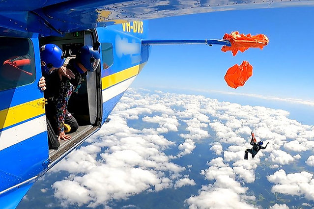 This frame grab taken from undated video footage provided by the Australian Transport Safety Bureau on December 11, 2025 shows the moment a skydiver was left dangling thousands of metres in the air after their parachute caught on the plane's tail. The skydiver survived the incident, which occurred south of Cairns during a stunt in September 2025 but has only just been revealed following investigations by the transport safety watchdog. (Photo by Handout/Australian Transport Safety Bureau/AFP via Getty Images)