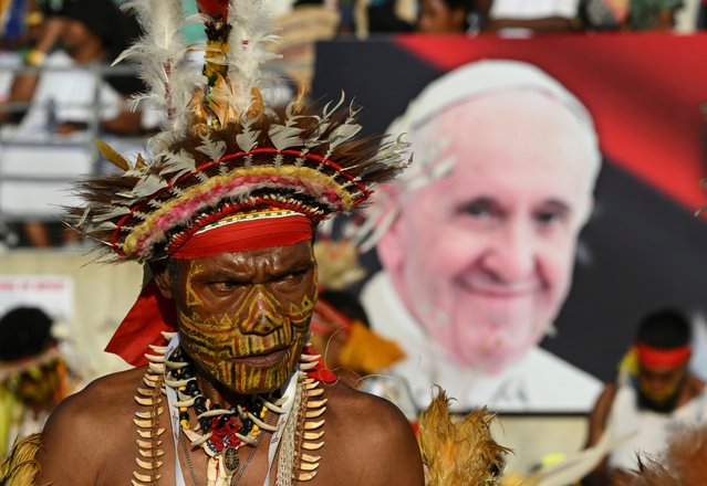 A worshipper wearing a traditional costume waits for Pope Francis to lead a Sunday mass at the Sir John Guise Stadium in Port Moresby, Papua New Guinea, 08 September 2024. Pope Francis is traveling from 02 to 13 September to conduct apostolic visits to Indonesia, Papua New Guinea, East Timor, and Singapore. (Photo by Alessandro Di Meo/EPA/EFE)